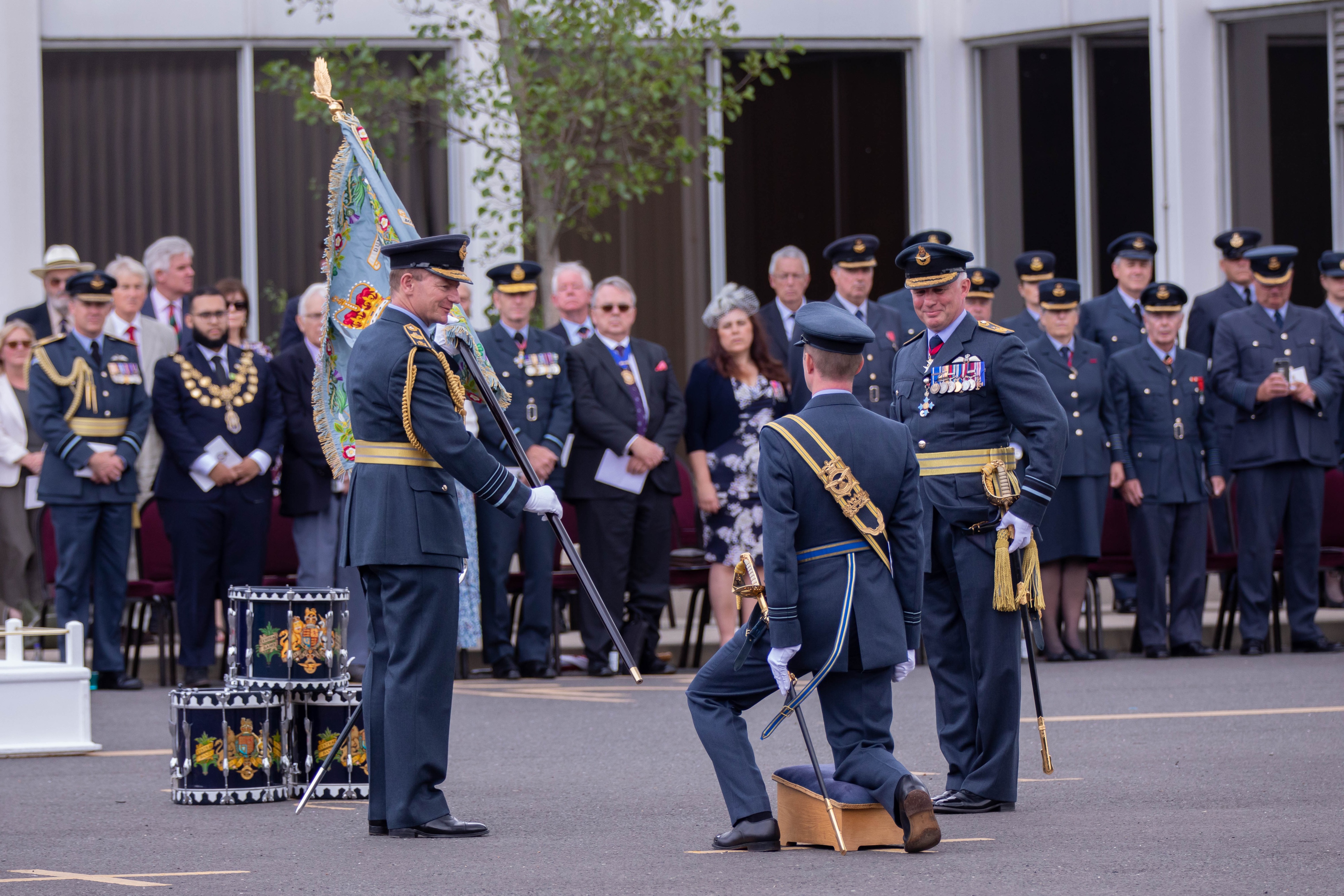 Image shows aviators stood during service, as Chief of the Air Staff hands over Standard.